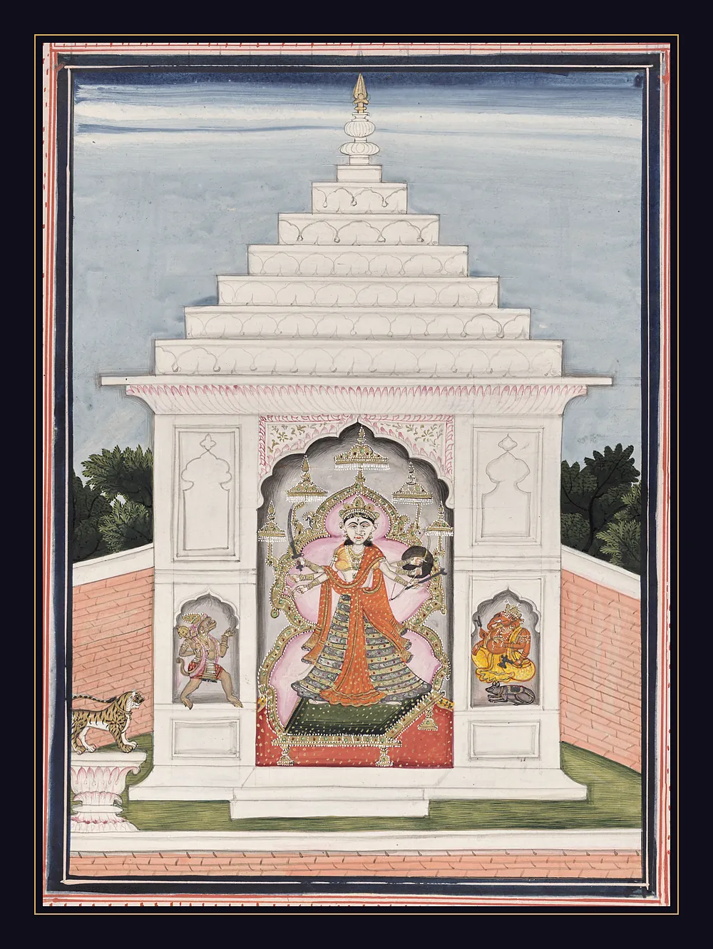 A white tiered shrine against a blue sky with a six-armed goddess in an orange sari inside, Hanuman and Ganesha in small niches on either side of the doorway, and a tiger on a pedestal at the left.